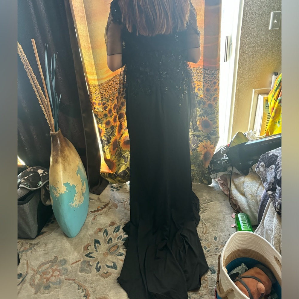 A very nice black dress comes from the brand royal queen collection